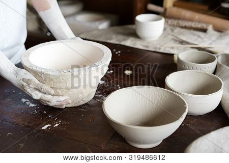 Female Hands Hold A Bowl For Casting Clay Products