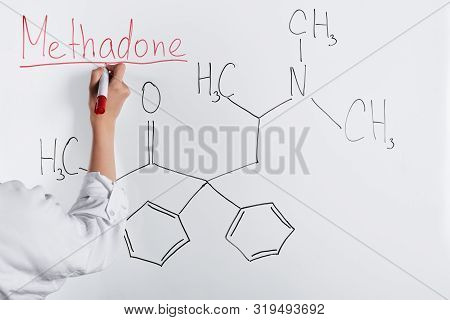 Cropped View Of Woman Writing Methadone On White Board