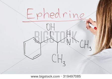 Cropped View Of Woman Writing Ephedrine On White Board