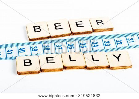 Health Concept Of A Tape Measure Also Showing The Message Beer Belly