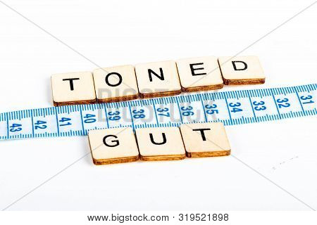Health Concept Of A Tape Measure Also Showing The Message Toned Gut