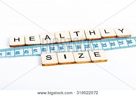 Health Concept Of A Tape Measure Also Showing The Message Healthy Size