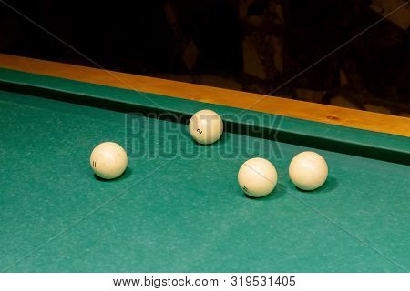 Ivory White Billiard Balls On A Green Pool Table. Triangle Or Pyramid On The Table.