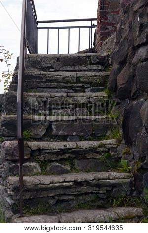 Korela Citadel; Old Stone Staircase Covered With Moss And Part Of The Masonry Of The Fortress Wall