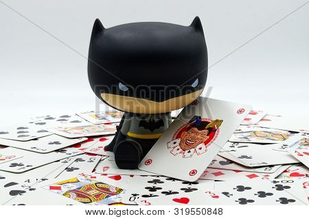 Bologna / Italy August 29, 2019: Funny Action Figure Of A Little Batman With A Playing Card Of The J