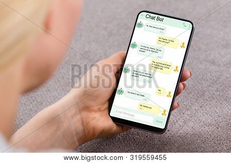 Close-up Of Woman Using Chat Bot Application For Chatting On Smartphone
