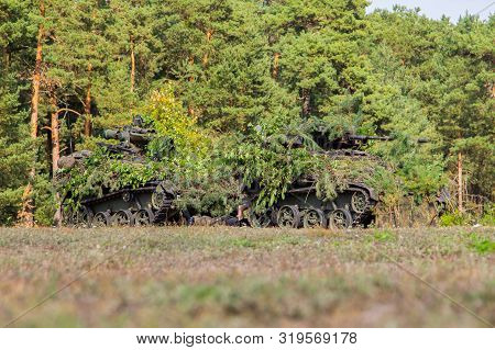 Armoured Weapons Carrier From German Army Stands At Military Training Area