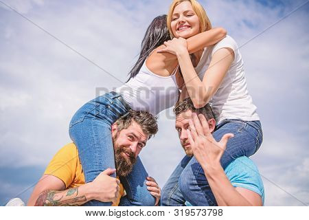 Men Carry Girlfriends On Shoulders. Summer Vacation And Fun. Couples On Double Date. Inviting Anothe