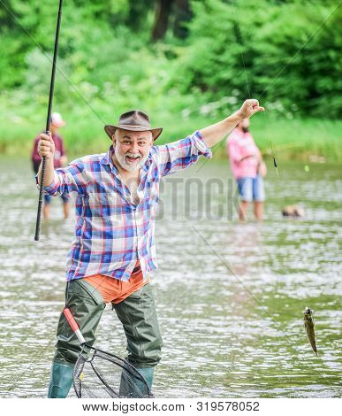 Fish On Hook. Man Senior Fisherman. Fisherman Fishing Equipment. Fisherman Alone Stand In River Wate