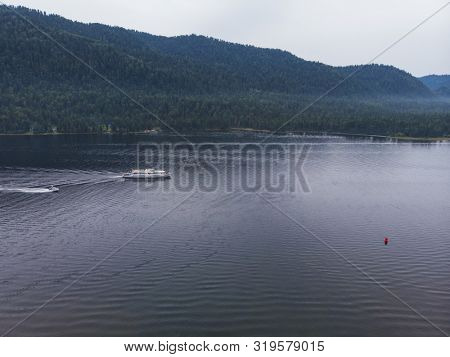 Aerial view on Teletskoye lake in Altai mountains, Siberia, Russia. Drone shot. Beauty panoramic picture in summer day.