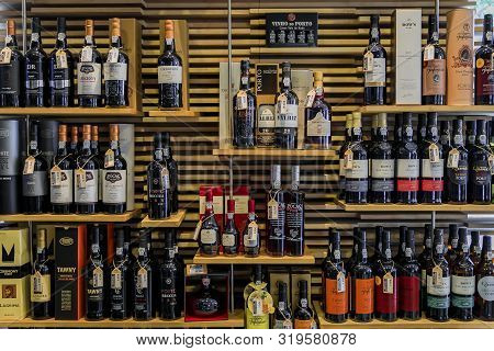 Porto, Portugal - May 30, 2018: Bottles Of Traditional Port Wine From Famous Producers On Display In