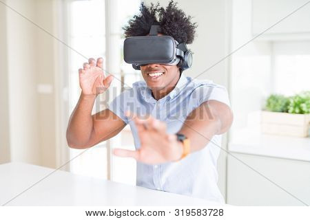 African amaerican man having fun playing with virtual reality glasses
