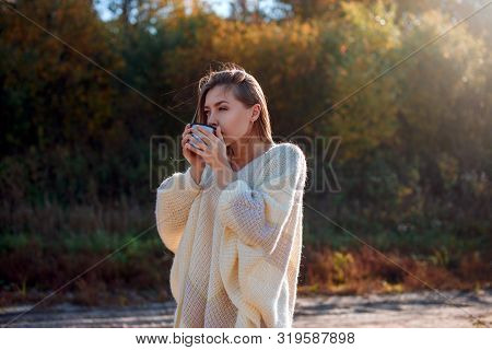 Beautiful Admiring Woman Drinking Hot Tea From Thermos Cup With Backligth Sun.