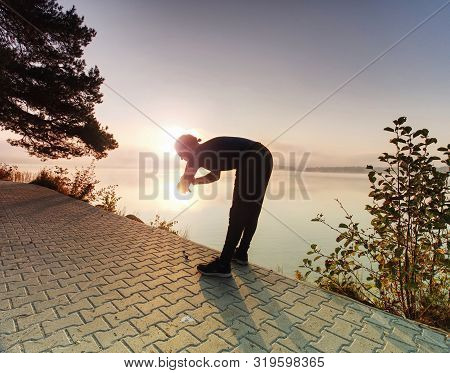 Man Running Looking At Heart Rate Monitor Watch Within Short Break.  Athlete With Bristle Looks At S