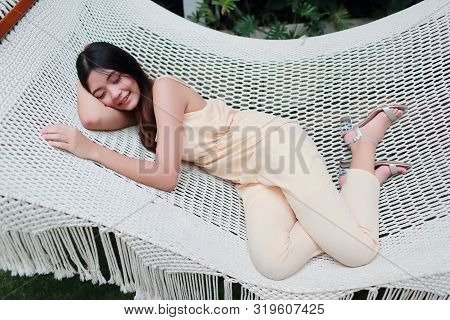 Young And Cute Asian Women Sleeping In A Hammock During Holiday