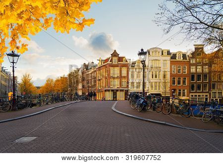 Stonepaved Street In Old Town With Historical Houses, Amstardam, Netherlands At Fall