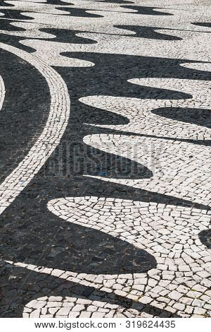 Traditional Portugues Pavement With Cobblestones In Black And White Combination, Cretaing A Design O
