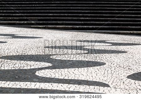 Traditional Portugues Pavement With Cobblestones In Black And White Combination, Cretaing A Design O