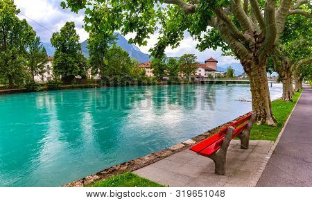 City Park Along The Bank Of Aare River In Old City Of Interlaken, Important Tourist Center In The Be