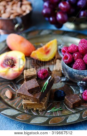 Norwegian Cheese Brunost On The Cutting Board .style Rustic.selective Focus