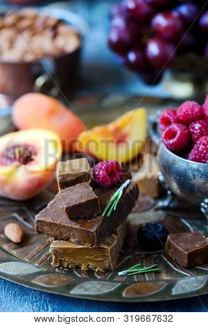 Norwegian Cheese Brunost On The Cutting Board .style Rustic.selective Focus