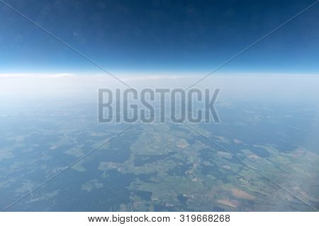 Airplane Window View To Cloudy Sky And Earth. Beautiful Landscape From Aircraft Cabin. Flying Withou