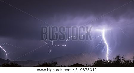 Summer Electrical Storm Produces A Lightning Bolt Illuminating A Valley In Rural Arizona