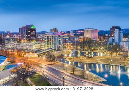 Huntsville, Alabama, USA park and downtown cityscape at twilight.