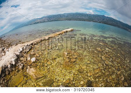 Old Stone Pier On The Adriatic Coast. Sea Coast Of Croatia. Calm Water. Beautiful Places Of European