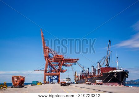 A cargo ship is loading with crane at Laemchabang port, Thailand. Logistics and transportation of Ca