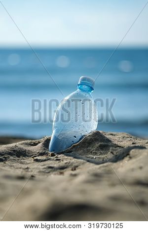 Plastic Bottle Is On The Beach Leave By Tourist. The Problem Of Pollution Of The Waters Of The Ocean