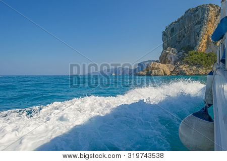 Rocky Coast Of The Island Of Sardinia In The Mediterranean Sea Viewed From A Boat