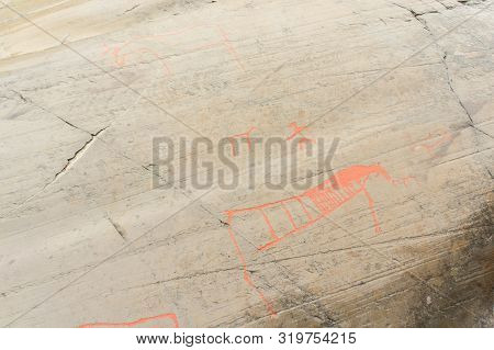 Rock Art In Alta Fjord, Norway. Ancient Symbols, Real Drawing,  Texture In Stone. Red Ocher Paint. H