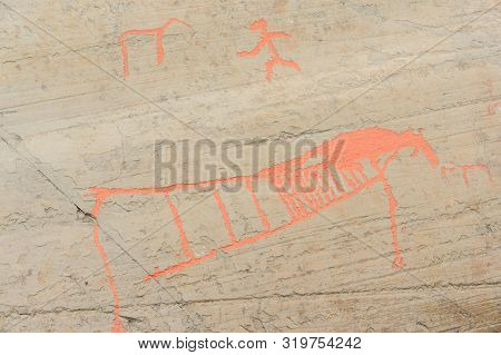Rock Art In Alta Fjord, Norway. Ancient Symbols, Real Drawing,  Texture In Stone. Red Ocher Paint. H