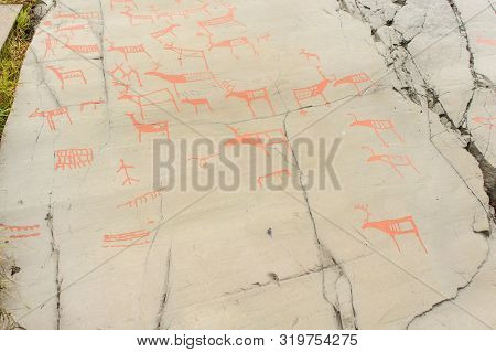 Rock Art In Alta Fjord, Norway. Ancient Symbols, Real Drawing,  Texture In Stone. Red Ocher Paint. H