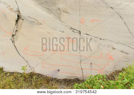 Rock Art In Alta Fjord, Norway. Ancient Symbols, Real Drawing,  Texture In Stone. Red Ocher Paint. H