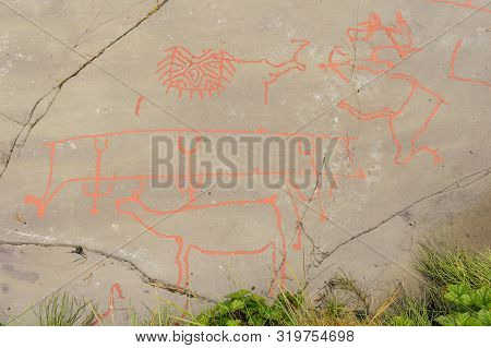 Rock Art In Alta Fjord, Norway. Ancient Symbols, Real Drawing,  Texture In Stone. Red Ocher Paint. H