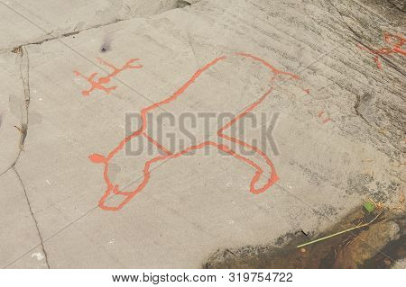Rock Art In Alta Fjord, Norway. Ancient Symbols, Real Drawing,  Texture In Stone. Red Ocher Paint. H