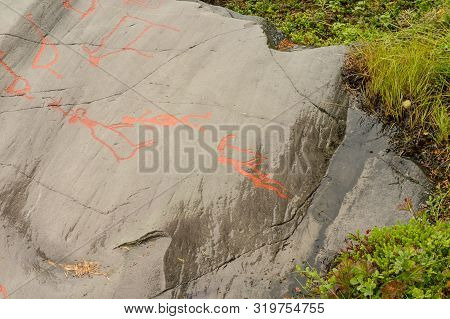 Rock Art In Alta Fjord, Norway. Ancient Symbols, Real Drawing,  Texture In Stone. Red Ocher Paint. H