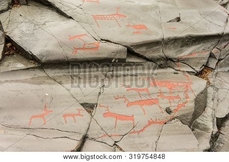 Rock Art In Alta Fjord, Norway. Ancient Symbols, Real Drawing,  Texture In Stone. Red Ocher Paint. H