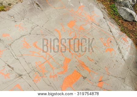 Rock Art In Alta Fjord, Norway. Ancient Symbols, Real Drawing,  Texture In Stone. Red Ocher Paint. H