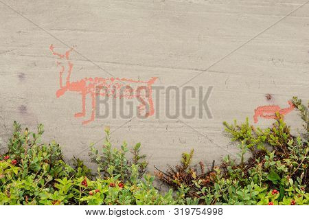 Rock Art In Alta Fjord, Norway. Ancient Symbols, Real Drawing,  Texture In Stone. Red Ocher Paint. H