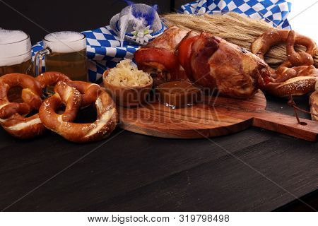 Traditional German Cuisine, Schweinshaxe Roasted Ham Hock. Beer, Pretzels And Various Bavarian Speci