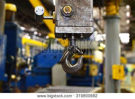 Crane Hook Of The Overhead Crane In The Workshop Of An Industrial Plant.  Push Remote Control Switch