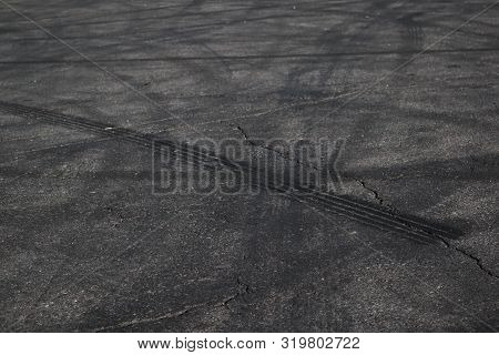 Tire Tracks. Wheel Track On Asphalt Road. Asphalt With Traces Of Car Wheels. Traces Of Braking From 