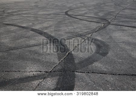 Tire Tracks. Wheel Track On Asphalt Road. Asphalt With Traces Of Car Wheels. Traces Of Braking From 
