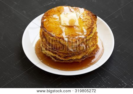 Homemade Corn Meal Johnny Cakes On A White Plate On A Black Surface, Side View. Close-up.