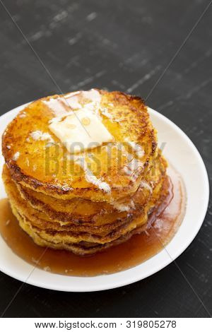 Homemade Corn Meal Johnny Cakes On A White Plate On A Black Surface, Side View. Copy Space.