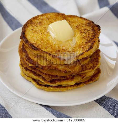Homemade Corn Meal Johnny Cakes With Butter On A White Plate, Side View. Closeup.