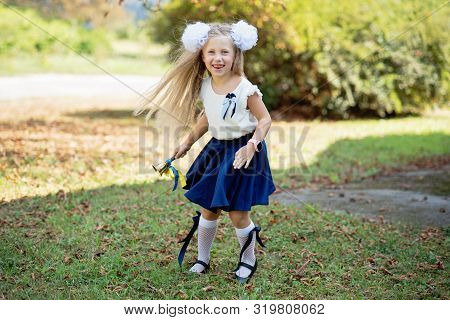 Portrait Of Beautiful Young Schoolgirl On Background School.